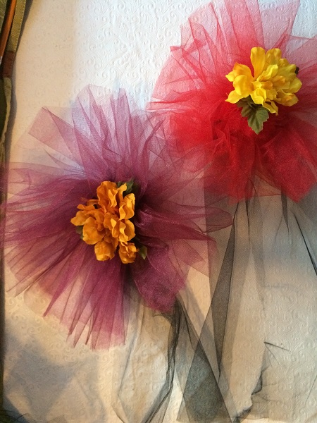 burgandy, red, black tulle with marigold flower pins
