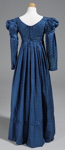 1824 Woman's royal blue brocade; empire waist; round neck; puffs at top of sleeves; belted at waist; center back opening. A separate pair of long sleeves (A-B) are also in royal blue brocade. North Carolina Museum of History