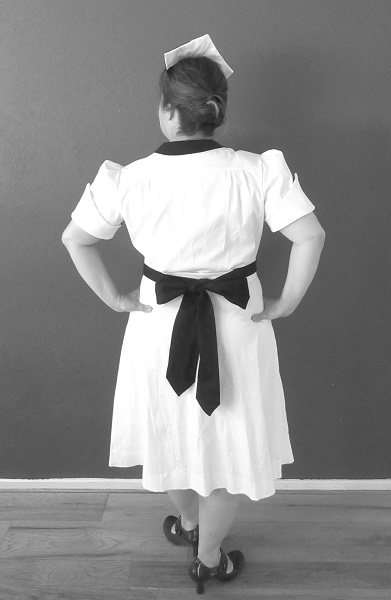 1950s Reproduction Candy Uniform Dress Back. Black and white